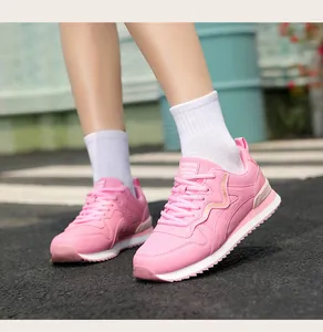 Side view close-up of stylish pink retro casual running sneakers for women outdoors