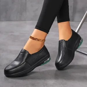 Close-up detail of black slip-on nursing shoes featuring air cushion and floral cutouts