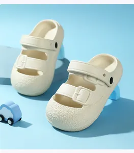 Beige children's closed-toe sandals with hollow buckle straps and textured anti-slip sole