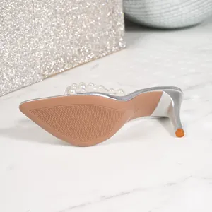 Detailed close-up view of silver high-heeled sandal featuring pearl-embellished transparent strap
