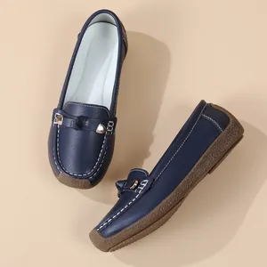 Navy blue soft-sole loafers for women featuring decorative buckle and white stitching