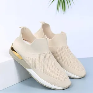 Profil latéral de baskets de course en maille beige respirante avec talon doré