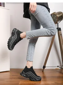 Detailed view of women's black knitted thick sole sneakers with breathable mesh on a model