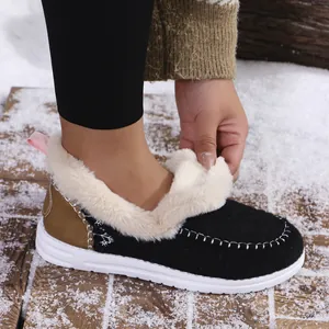 Detail view showing the soft faux fur lining and stitching on black winter moccasin shoes.