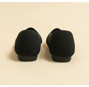 Detailed back view of black breathable knitted flats showcasing premium mesh texture
