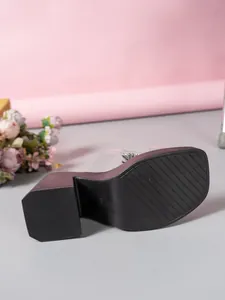 Close-up of the anti-slip thick sole and heel of rhinestone platform slippers