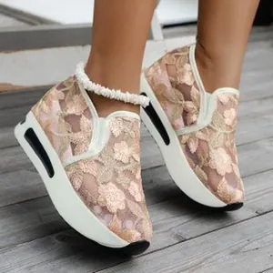 Detailed view of the elegant floral embroidery on these breathable mesh wedge sneakers