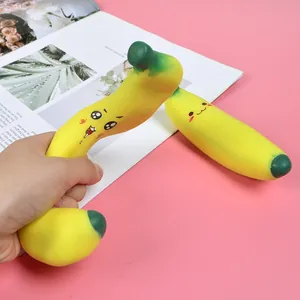 Close-up of cute banana-shaped TPR squishy stress relief toy being squeezed by a person