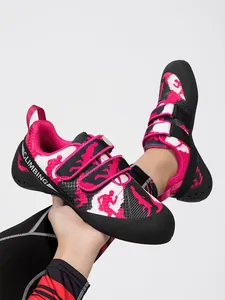 Detail view of pink rock climbing shoe with Velcro straps and climbing silhouettes