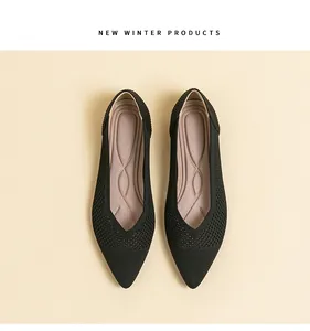 Detailed view of elegant black knit pointed-toe flats with breathable hollow-out design.