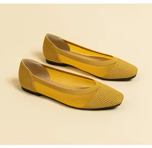 Detailed view of yellow breathable knitted square-toe flats with ribbed texture
