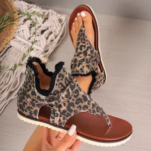 Detailed view of leopard print thong sandals with back zipper and frayed edges