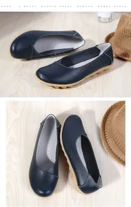 Detailed macro view showing texture of dark blue genuine leather women loafers shoes