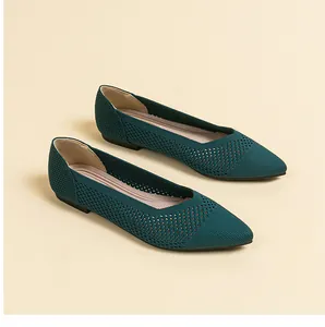 Macro view of dark teal pointed-toe knit flats with an elegant breathable hollow-out pattern
