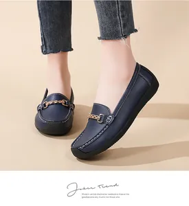Close-up view of comfortable navy blue women's loafers with gold buckle detail