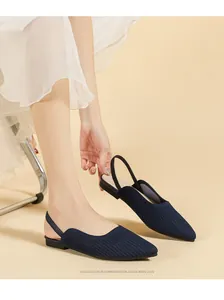 Detail view of navy blue knit pointed-toe slingback flats with soft elastic strap