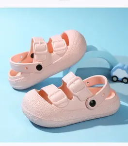 Close-up of pink children's buckled sandals featuring a breathable hollow design