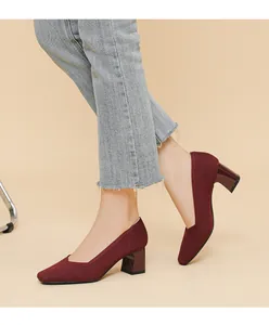 Detail view of burgundy chunky heel pumps with square toe and ribbed knit texture