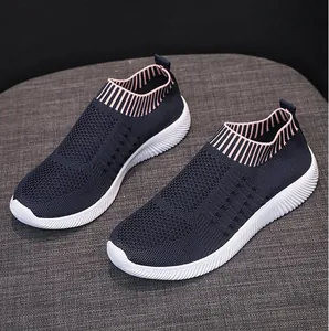 Dettaglio di sneaker slip-on in maglia blu navy con colletto a righe rosa chic