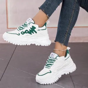 Detail view of stylish white and green fishbone chunky sneakers with breathable mesh