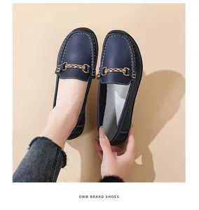Detailed view of navy blue soft-soled loafers for women with decorative gold chain