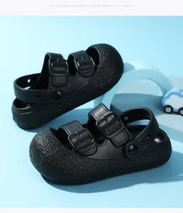 Side detail of black children's closed-toe sandals featuring soft soles and double buckle straps.