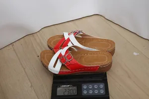 Detail view showing weight of red and white platform sandals on a scale