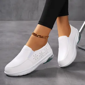 Close-up detail of white breathable leather air-cushion slip-on nurse shoes on model