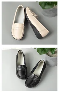 Detailed view of beige and black leather loafers for women with anti-slip soles.