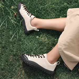 Detailed shot of beige wide toe outdoor barefoot sneakers worn on green lawn