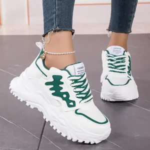 Detailed close-up of the fishbone side pattern on white and green chunky sneakers