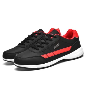 Professional black and red leather casual sneakers featuring a waterproof metal tag detail