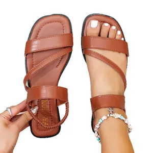 Brown flat Roman sandals for women, casual beach style with elastic strap