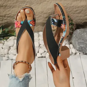 Side view showing colorful floral print and sturdy wedge heel of summer thong sandals