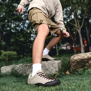 Detailed view of beige barefoot outdoor shoes with wide toe box in a park setting.