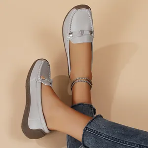 Close-up of grey soft-soled loafers worn with denim for a casual look