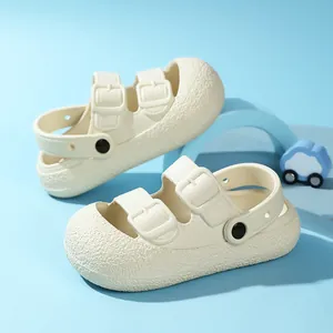 Cream white kids' closed-toe sandals with dual buckle straps and soft anti-slip soles