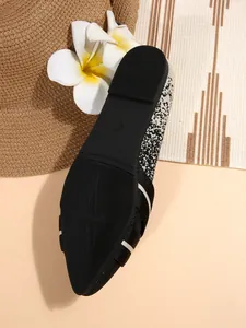 Detailed view of the anti-slip black sole of a fly-knit pointed-toe flat shoe for women