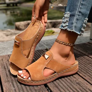 Gros plan sur des mules compensées élégantes avec boucle en métal et jolies coutures