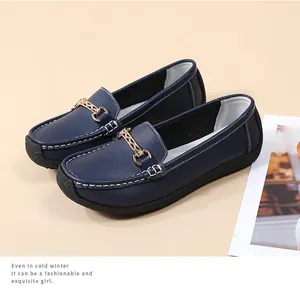 Elegant dark blue women's loafers with a decorative gold chain and soft leather finish