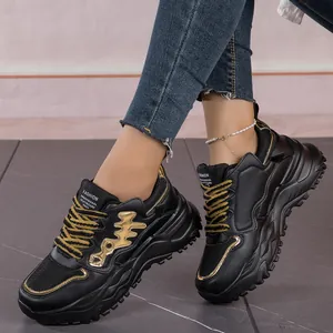 Detailed side view of black women's fashion chunky sneakers with gold fishbone design