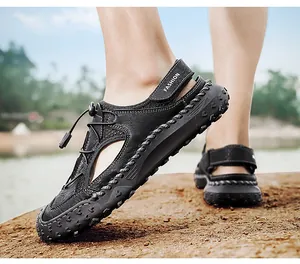 Close-up of black genuine leather men's sandals with breathable cutouts