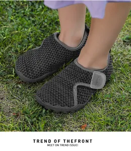 Breathable grey mesh toddler shoes with soft soles shown worn on grass outdoor.