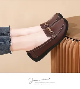 Detailed view of comfortable brown leather loafers for women with stylish gold chain ornament