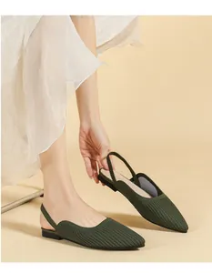 Pointed-toe dark green knitted slingback flat sandals shown on foot for elegant style