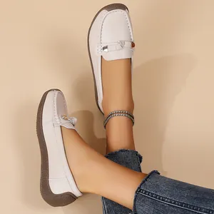 Detailed view of comfortable off-white leather loafers with soft brown soles for women.