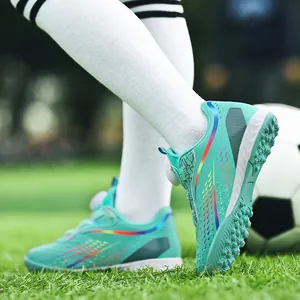 Teal children's turf soccer shoes featuring a convenient rotary buckle for boys and girls