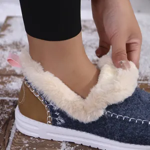 Detail of women's warm winter shoes with soft faux fur lining and blue fabric upper.