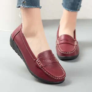 Elegant burgundy leather loafers for women featuring comfortable flat black rubber soles.