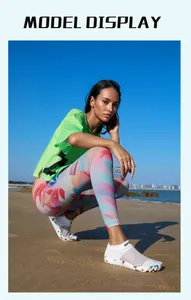 Model wearing white five-finger water shoes on a sunny beach detail lifestyle view